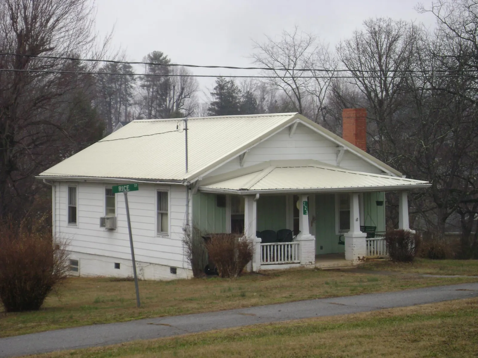 White metal roof on a craftsman bungalow at a street corner in Sevier